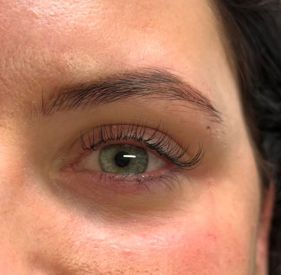 Classic lash extensions on green eye — clean, natural definition